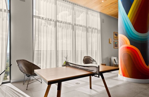 Rainey Street Historic District Condo | Designer Condo Steps to Lady Bird Lake with gym & rooftop pool