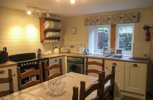 Kettlewell Cottage | Detached barn conversion with side terrace overlooking the river.