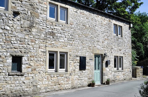 Kettlewell Cottage | Detached barn conversion with side terrace overlooking the river.