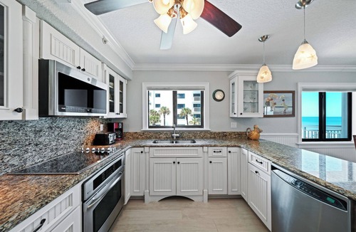 New Smyrna Beach Condo | Direct oceanfront corner 3/2 with a large wrap around balcony and heated pool