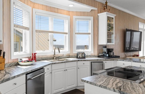 Caswell Beach House | Discover Peace on the Beach, a stunning 6BR, 5BA oceanfront retreat in Oak Island.