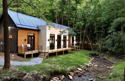 Scaly Mountain House | E Ranch is a modern, creek side, Scandinavian barnhouse.
