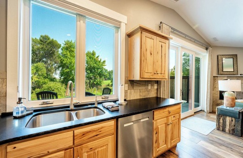 Sheridan Condo | Elegant 2BD, 2BA creekside retreat in Powderhorn Golf Community. This private guest suite comfortably fits 4 & features a cozy fireplace, beautiful kitchen & expansive patio w/a BBQ overlooking Goose Creek. Perfect for a quiet getaway.