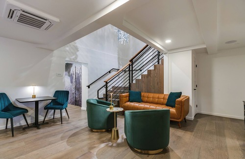 San Angelo Hotel | Elegant Suite with Separate Living Room & Mini Fridge – Ideal for Relaxation and