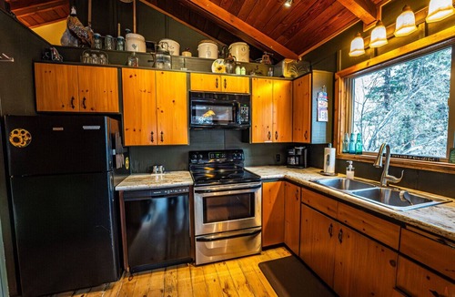 Sundance Cabin | Elevated creekside escape Set in the trees Hot tub Private setting Above Sundance Canyon