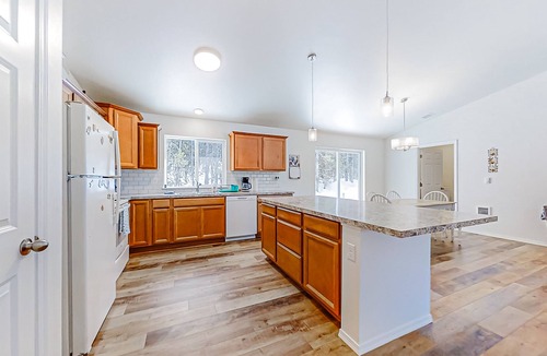 Crescent House | Enchanting 10-acre retreat with waterfront views & spacious deck