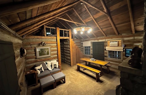 Aurora Cabin | Enjoy a cozy getaway in a rustic log cabin on Kentucky Lake. With Hottub