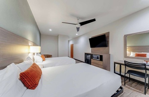 Eastside Promise Neighborhood Hotel | Enjoy Comfort in a Cozy Room w/Convenient Amenities - Perfect for Any Stay