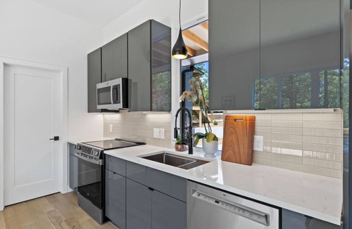 Young Harris Apartment | Escape to a 2BR/1BA tiny home in the N Georgia mountains. Cook meals, cozy up by the wood-burning stove, refresh in the spa-style shower, and enjoy crisp winter mountain air from your private deck. Perfect for city escapes and romantic weekends.