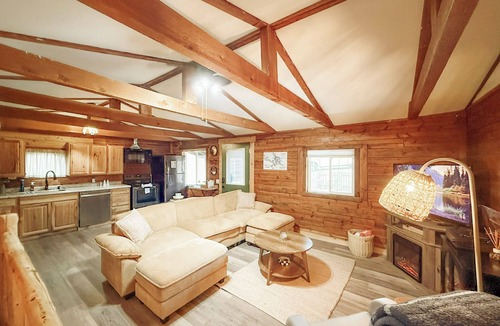 Lake Ozark House | Escape to Grandpa John’s Cabin in Four Seasons near Shady Gators & Camden on the Lake. This restored 2 bed, 2 bath log cabin features a king suite, bunk room, fireplace, coffee bar, deck, firepit, pet-friendly stay, and parking for cars & small boat.