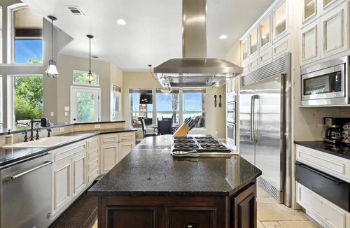 Rocky Ridge House | Experience luxury on Lake Travis! Enjoy stunning lake views, a private pool, spa, fire pit, and plenty of space for the whole crew. This gated retreat sleeps 17+ and features a chef’s kitchen, bar, media room, game room, dedicated office, playscape,