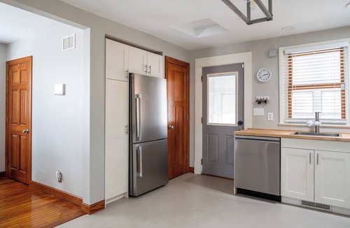 Midway House | Follow the Yellow Front Door to a welcoming home close to everything.