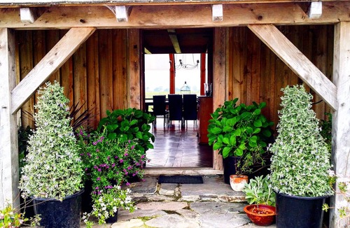 Richmond Downs House | Handhewn Barn in a field
