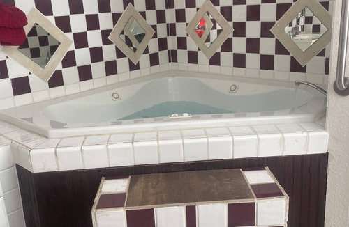 Eminence Cottage | Hogan's Hideout Duplex #20 Jacuzzi Room is a relaxing, cozy room