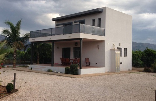 Pego Ski Chalet | house among orange trees .