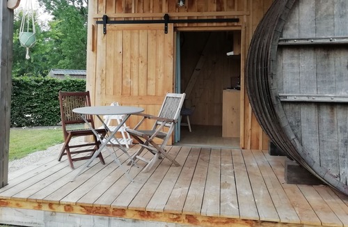 Baguer-Pican Cabin | INSOLITE A barrel in a green setting