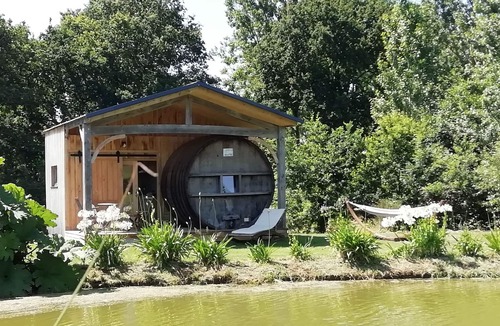 Baguer-Pican Cabin | INSOLITE A barrel in a green setting