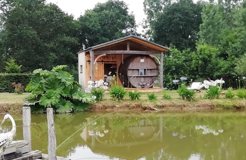 Baguer-Pican Cabin | INSOLITE A barrel in a green setting