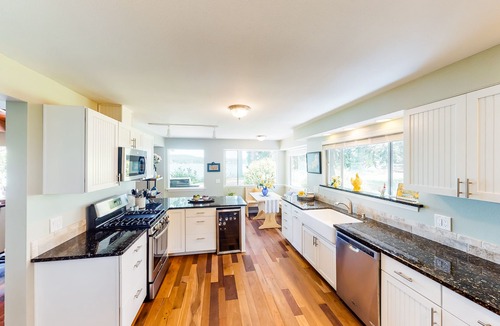 Poulsbo House | Inviting bayside dwelling with beach access, deck, waterfront views, & fireplace