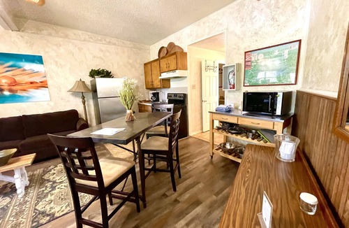 Mount Ida Cabin | King Studio with king bed, dining area, sleeper sofa and view of Lake Ouachita by RedAwning