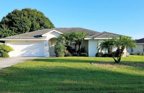 Pebble Beach House | La dolce vita awaits in this immaculate pool home on fresh water canal.