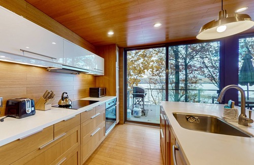 Valois House | Lakefront contemporary gem with decks, lake views & pebble beach