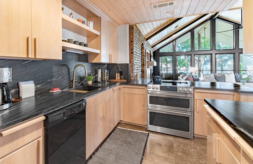 Tool House | Lakefront home with luxury touches. Ample outdoor space for making memories.