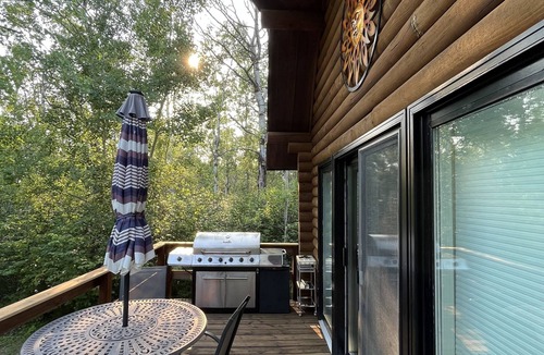 Onanole Cottage | Lakefront Log Cabin with HOT TUB. Unique property with private lake access.