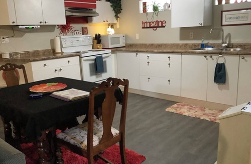 Rosemount Apartment | Large private fenced yard with guest patio, fire pit and surrounding gardens.