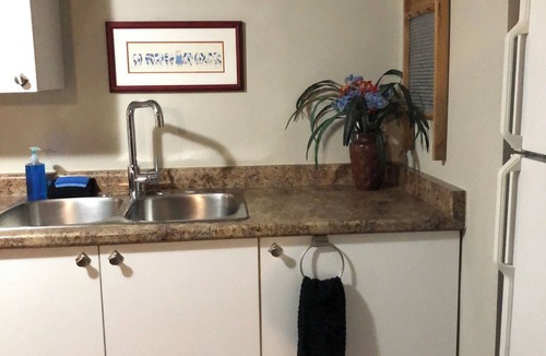 Rosemount Apartment | Large private fenced yard with guest patio, fire pit and surrounding gardens.