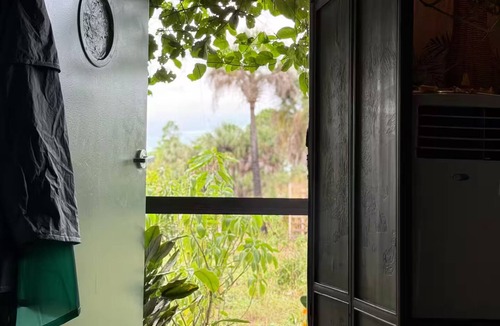 Rural Estates Cabin | Luxury off-grid passionfruit covered shipping container immersed in nature.