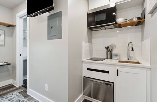 Ocean Cay Apartment | Luxury Studio Steps to Beach Kitchenette Outdoor Seating Partial View Upstairs