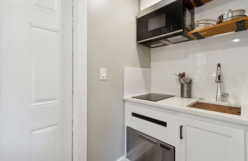 Ocean Cay Apartment | Luxury Studio Steps to Beach Kitchenette Outdoor Seating Partial View Upstairs
