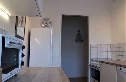 Brabrand Condo | M H Homes Apartments with a fully equipped kitchen.