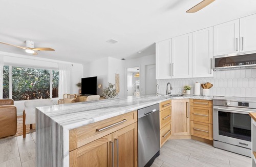 Central Corals House | Marigold House - Tropical Getaway w/large yard & heated pool 2 mi from the beach