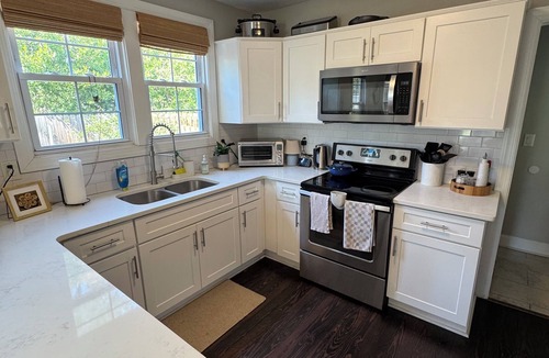 Pendleton King House | Masters rental with spacious back porch, fenced in yard, and park frontage.