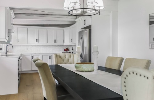 Stokes Bay House | Midnight Star is a bright, modern Stokes Bay waterfront cottage with 3 bedrooms, 2 bathrooms, a private dock, sauna, hot tub, stone fireplace, open-concept living, and epic sunsets—perfect for easy Bruce Peninsula lake days.