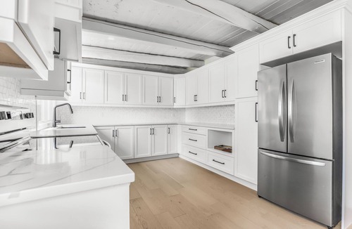 Stokes Bay House | Midnight Star is a bright, modern Stokes Bay waterfront cottage with 3 bedrooms, 2 bathrooms, a private dock, sauna, hot tub, stone fireplace, open-concept living, and epic sunsets—perfect for easy Bruce Peninsula lake days.