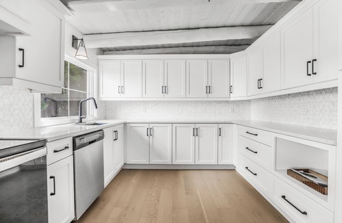 Stokes Bay House | Midnight Star is a bright, modern Stokes Bay waterfront cottage with 3 bedrooms, 2 bathrooms, a private dock, sauna, hot tub, stone fireplace, open-concept living, and epic sunsets—perfect for easy Bruce Peninsula lake days.