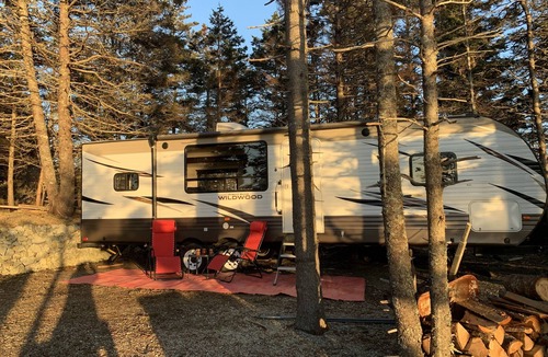 Clare House | Modern RV camper with all the perks nNestled in tree at lake edge