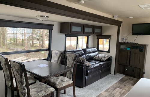 Clare House | Modern RV camper with all the perks nNestled in tree at lake edge