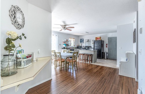 Woods Bay House | Mountain-view home with large deck, gas grill, firepit, lawn, and central AC