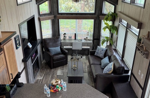 Portage RV Rental | MTM Premier - The Funky Duo combines Funky Island and Funky Jungle—two side-by-side lakefront properties sleeping 12 total. A bright park model and cozy log cabin with shared campground amenities, perfect for larger groups.