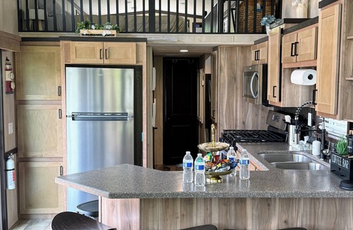 Portage RV Rental | MTM Premier - The Funky Duo combines Funky Island and Funky Jungle—two side-by-side lakefront properties sleeping 12 total. A bright park model and cozy log cabin with shared campground amenities, perfect for larger groups.