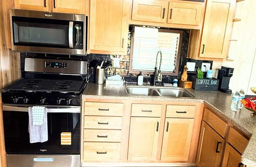 Portage RV Rental | MTM Premier - The Funky Duo combines Funky Island and Funky Jungle—two side-by-side lakefront properties sleeping 12 total. A bright park model and cozy log cabin with shared campground amenities, perfect for larger groups.