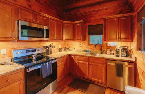 Almond Cabin | Must-Know Perks: Private hot tub + relaxing soaking tub Luxurious king bed in a cozy, intimate space Peaceful wooded setting near the Smoky Mountains
