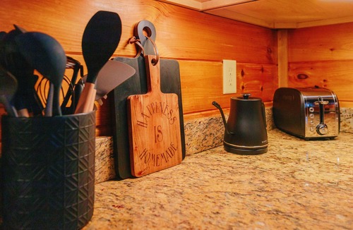 Almond Cabin | Must-Know Perks: Private hot tub + relaxing soaking tub Luxurious king bed in a cozy, intimate space Peaceful wooded setting near the Smoky Mountains