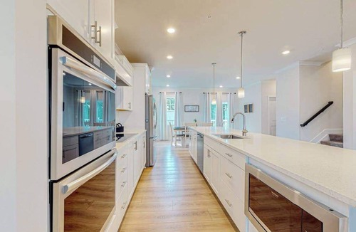 Ocean City Condo | Newly built row-end townhome with water view, pool access, patio, & balcony