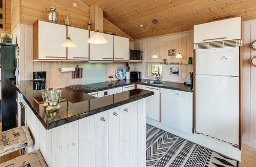 Sklskr House | Nice and bright cottage with a kitchen that is partly open to the dining and living room.