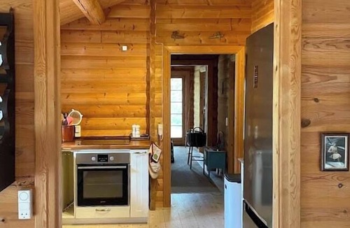 Rrvig House | Norwegian log cabin among heather and pine trees